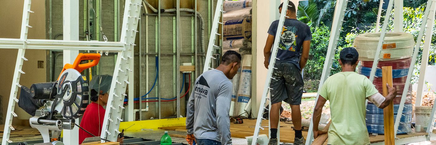 Quality Homes By The Black Sheep construction team working on site in Costa Rica — steel frame and hardwood flooring installation